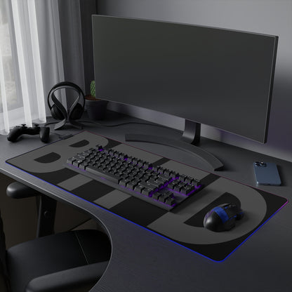 A black gaming mousepad for traders made with smooth soft cloth and fine fabric, BTFD written in bold dark grey, LED light strip surrounds the edges, Memes for traders