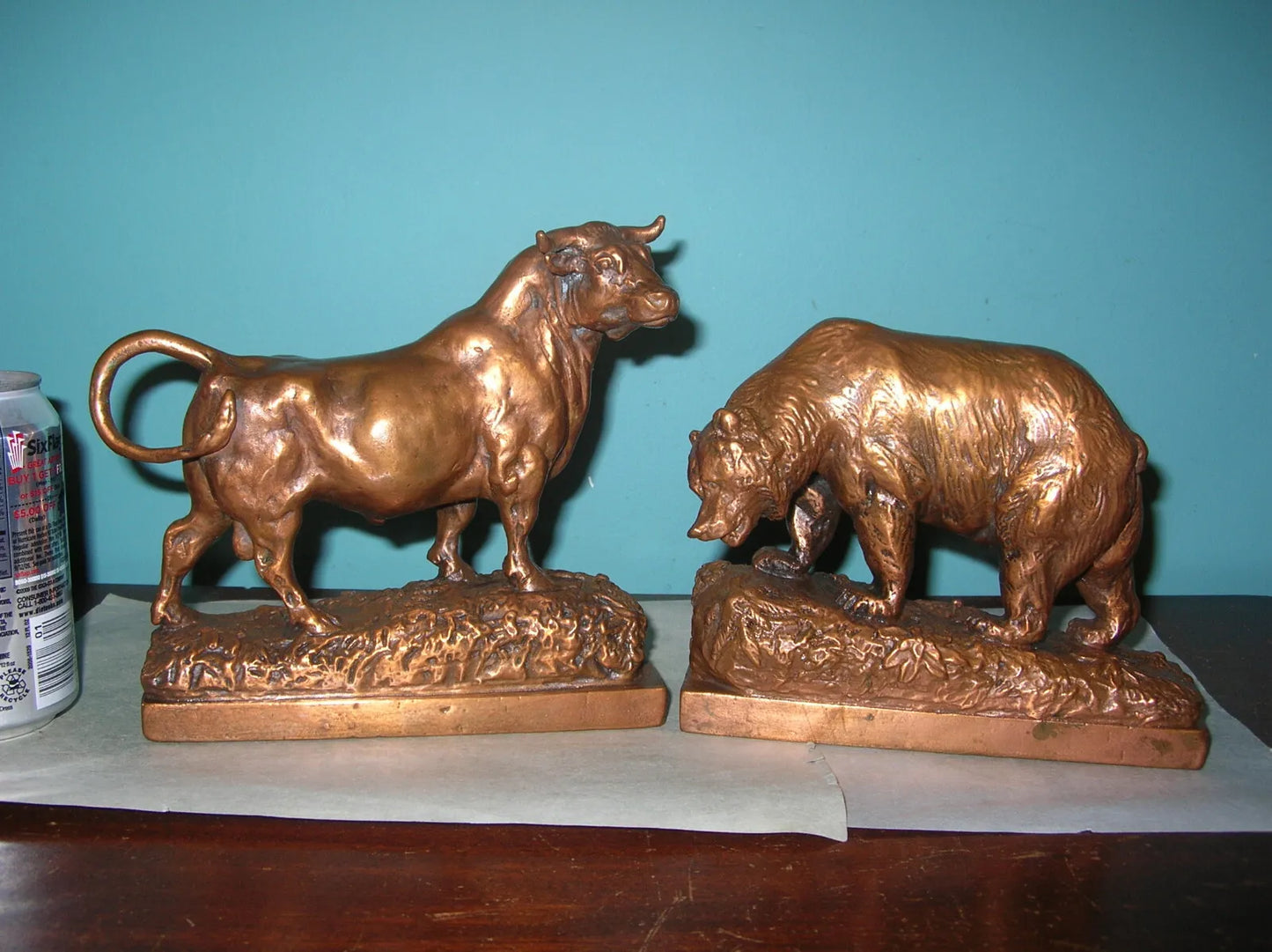 Antique Pompeian Bronze-clad bookends by Paul Herzel, featuring a bull and a bear, symbolizing Wall Street, showcasing intricate detail and craftsmanship.