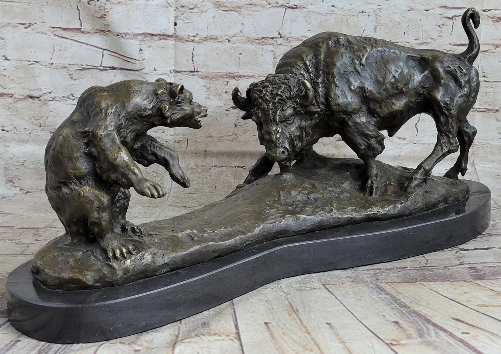 Signed bronze sculpture of a bull and grizzly bear, symbolizing stock market trends, in dynamic combat pose.