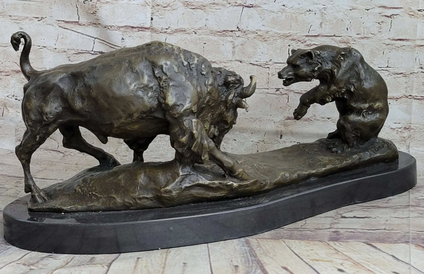 Signed bronze sculpture of a bull and grizzly bear, symbolizing stock market trends, in dynamic combat pose.